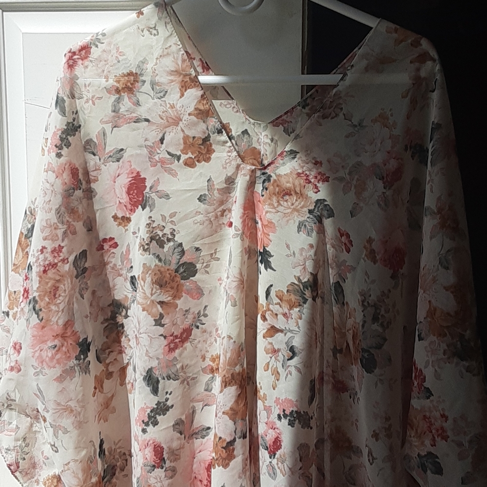 See through/sheer fabric with pink flowers.